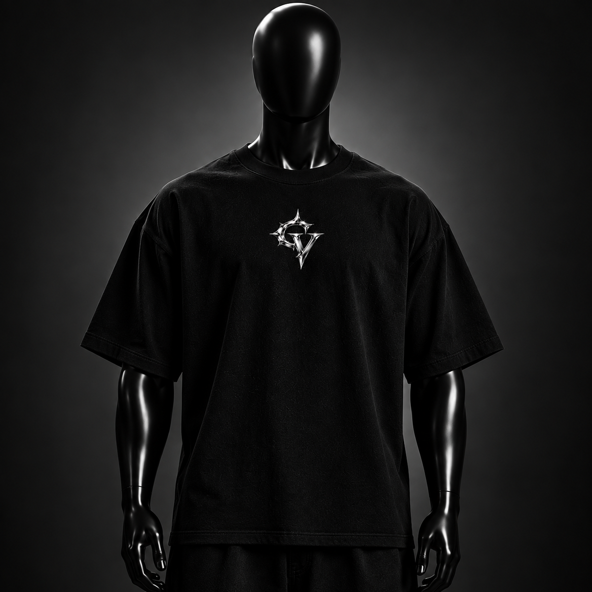 Chrome Globe Tee — front, chrome GV chest mark on black oversized tee. Concept render, internal review only.